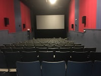 a theater with rows of seats and a projection screen